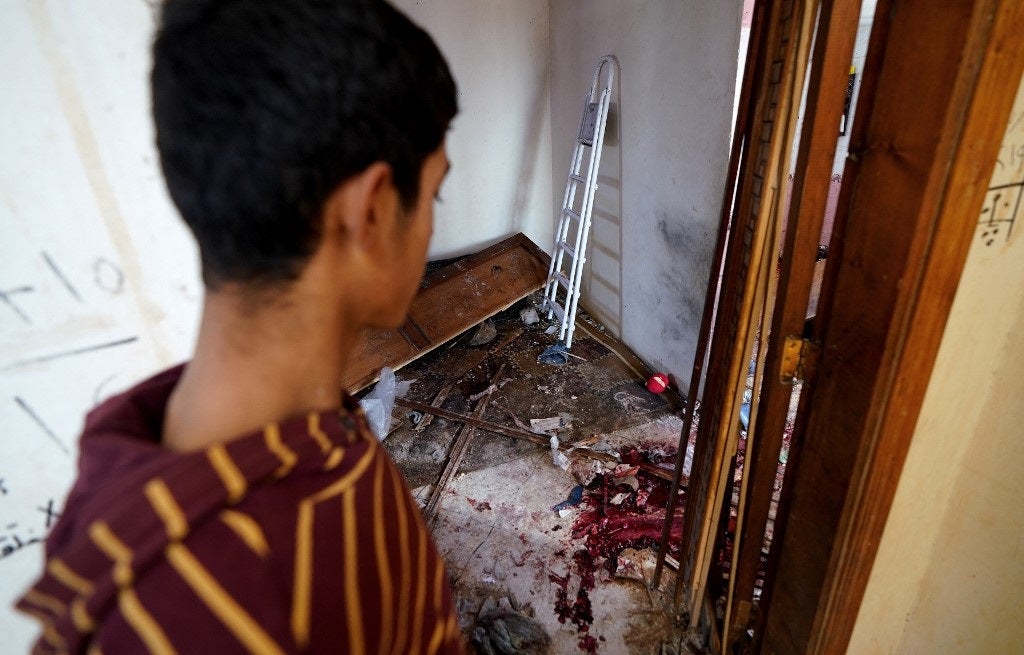 A young Syrian boy looks on at the damage following an overnight raid by US special operations forces against suspected jihadists in Atmeh, in Syria's northwestern province on February 3, 2022. Muhammad Haj Kadour/AFP